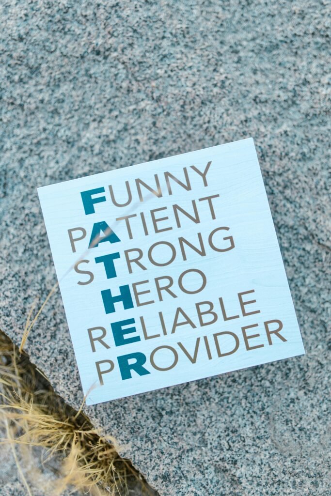 Vertical shot of a Father's Day card with inspiring words on a textured stone surface.